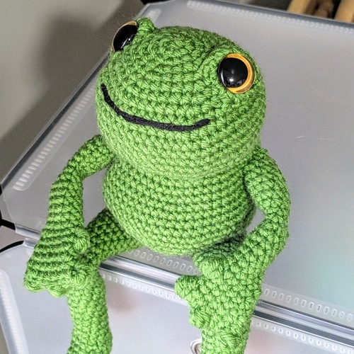 Sitting long-legged frog